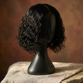 10 inch Deep Wave Curly Bob Wig on black mannequin head, side profile view, warm terracotta background — Amarrah Beauty